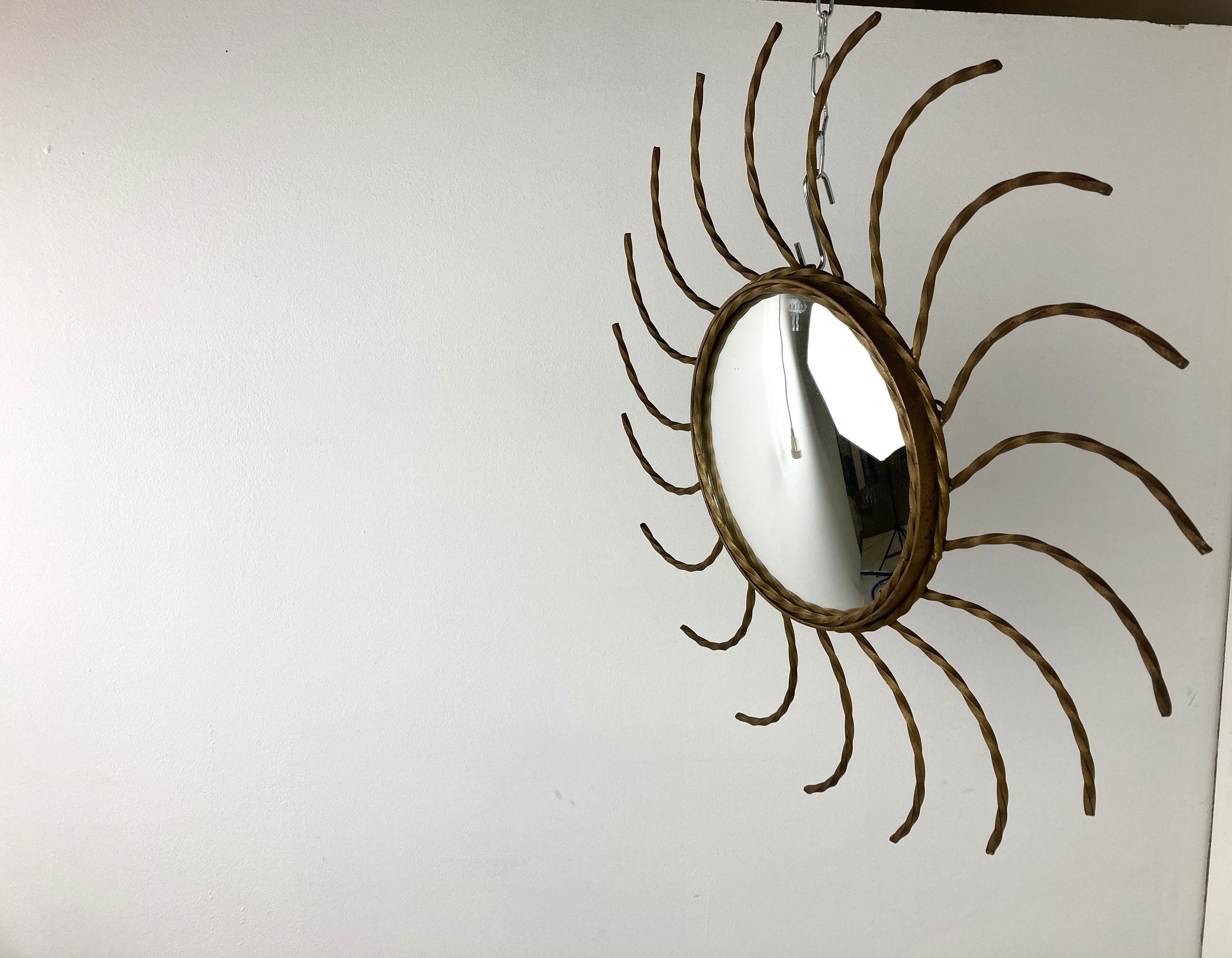 Mid century gold sunburst mirror with convex glass.