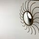 Mid century gold sunburst mirror with convex glass.