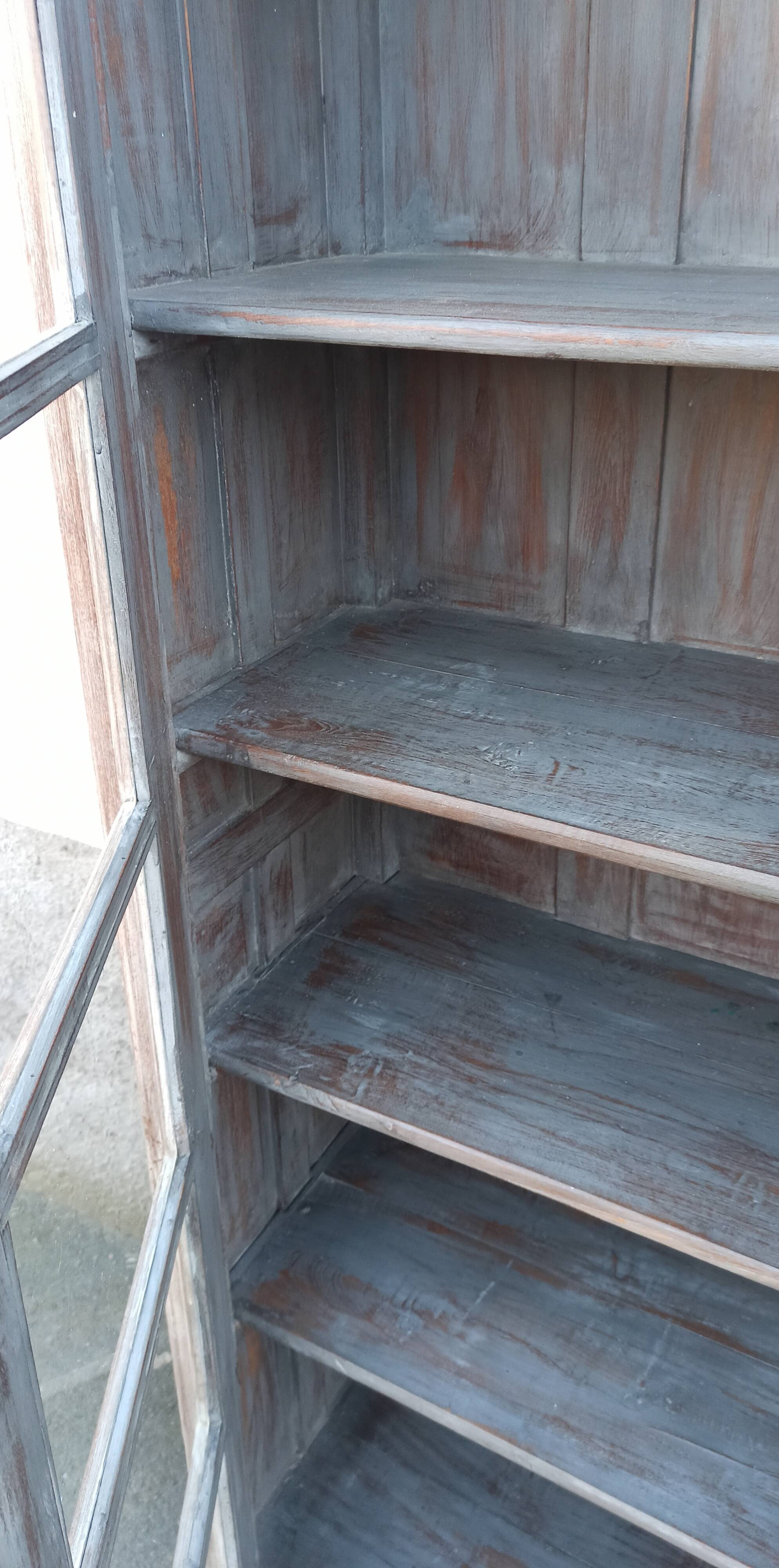 Glass cabinet in old whitewashed wood