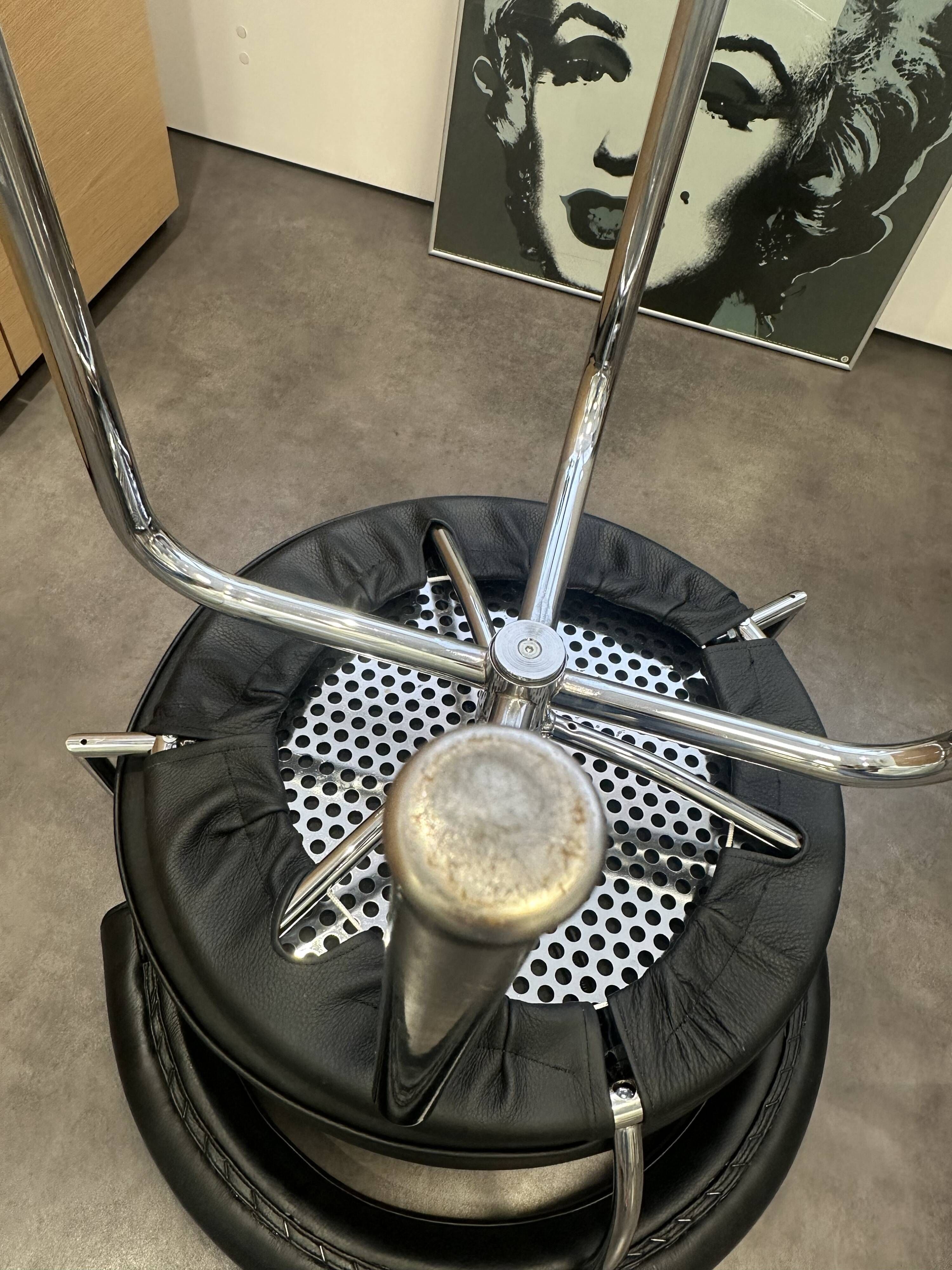 LC7 Swivel Armchair in black leather by Charlotte Perriand for Cassina