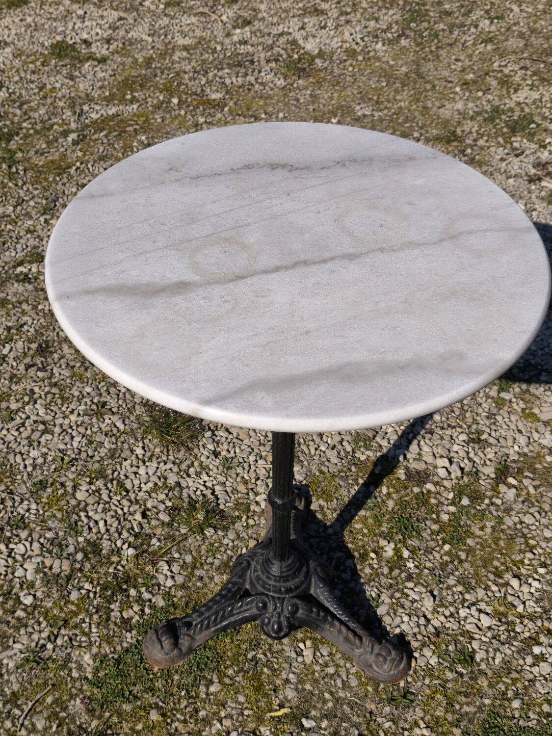Marble bistro table with cast iron legs in Parisian café style