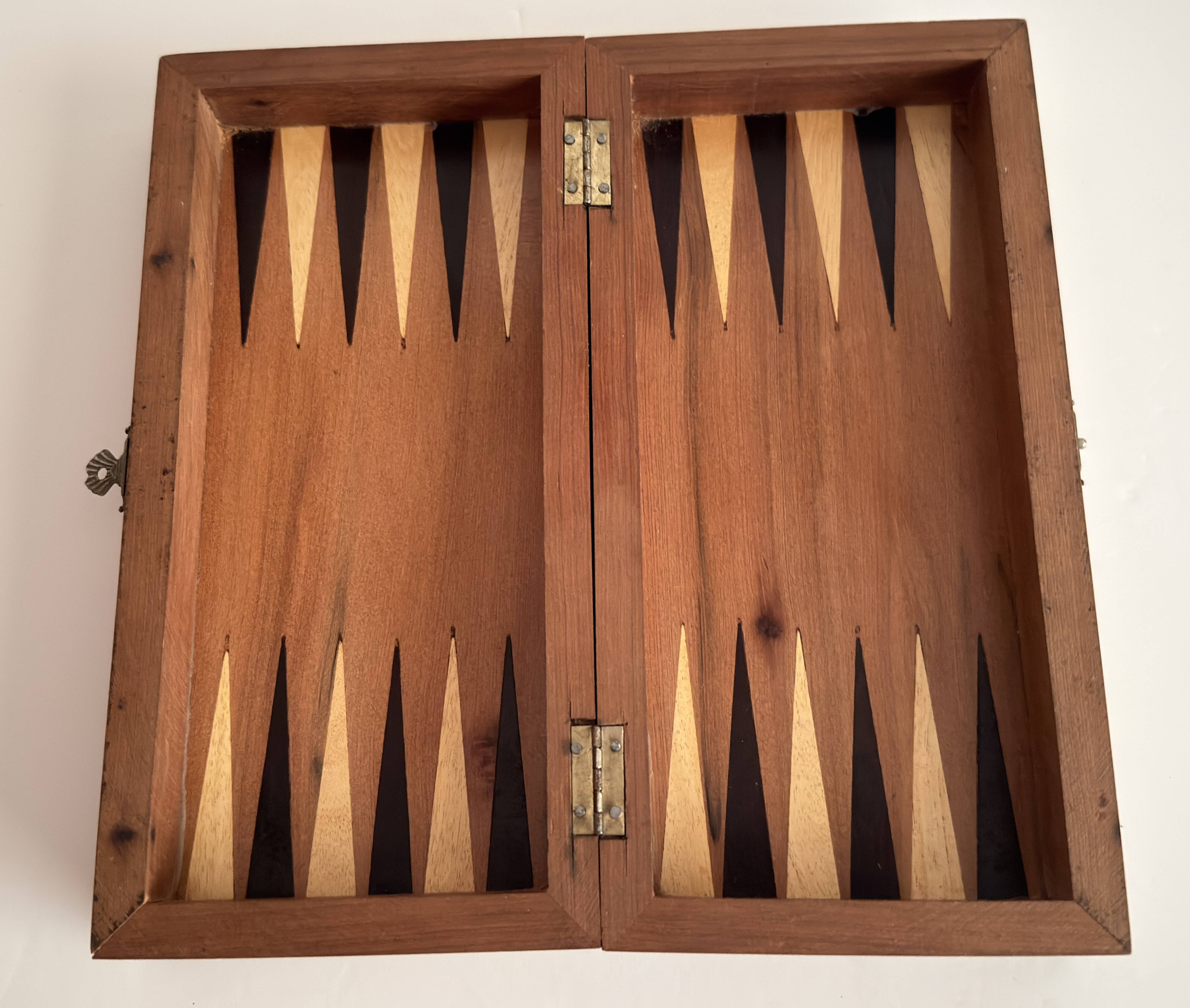 Old wooden chess set with a folding wooden box.