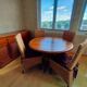 Round wooden table with wrought iron legs.