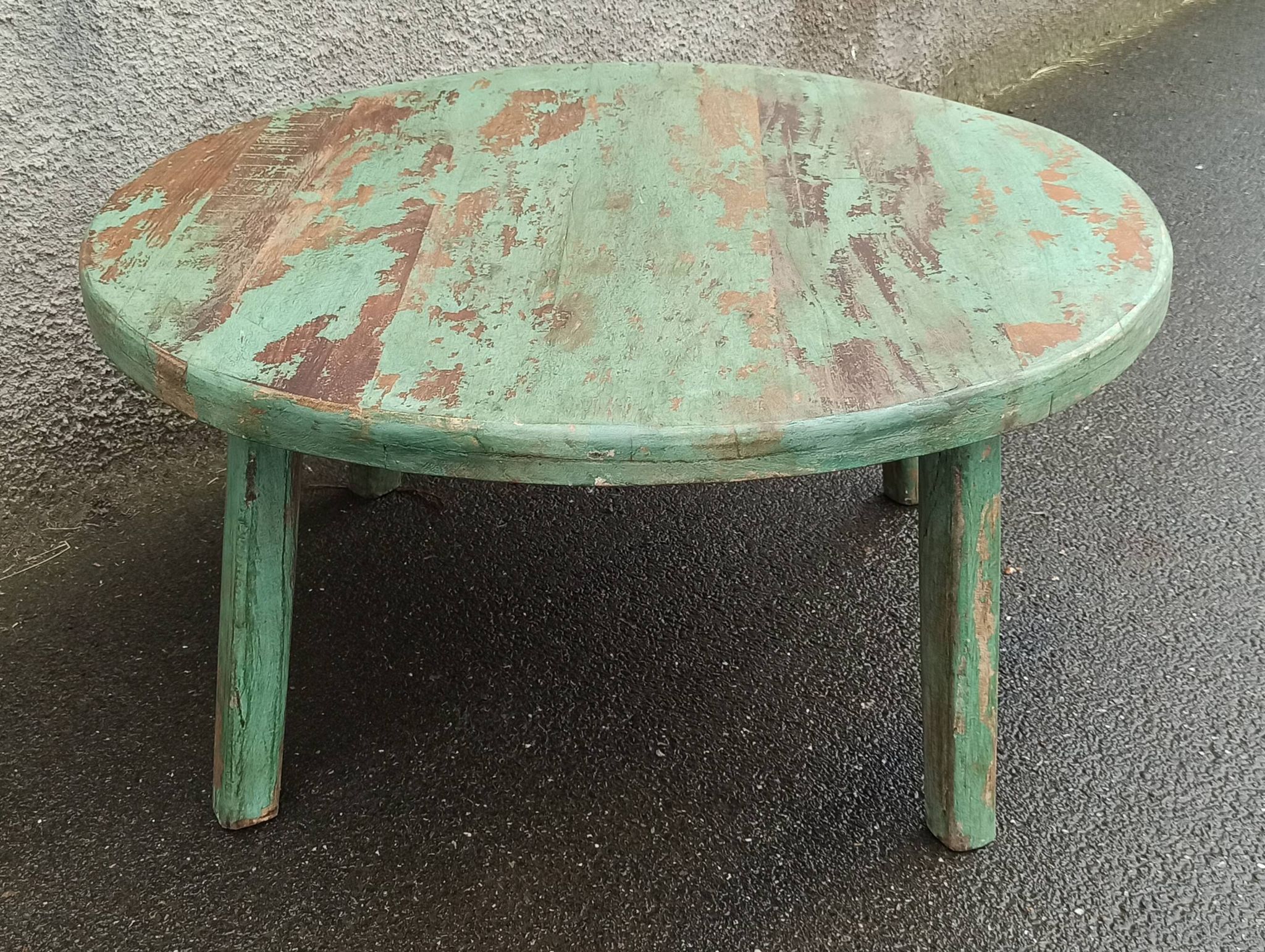 Round coffee table in old green wood