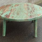 Round coffee table in old green wood