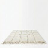 Berber rug with a white graphic pattern.