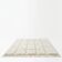 Berber rug with a white graphic pattern.