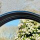 Vintage round smoked plastic mirror, circa 1970s.