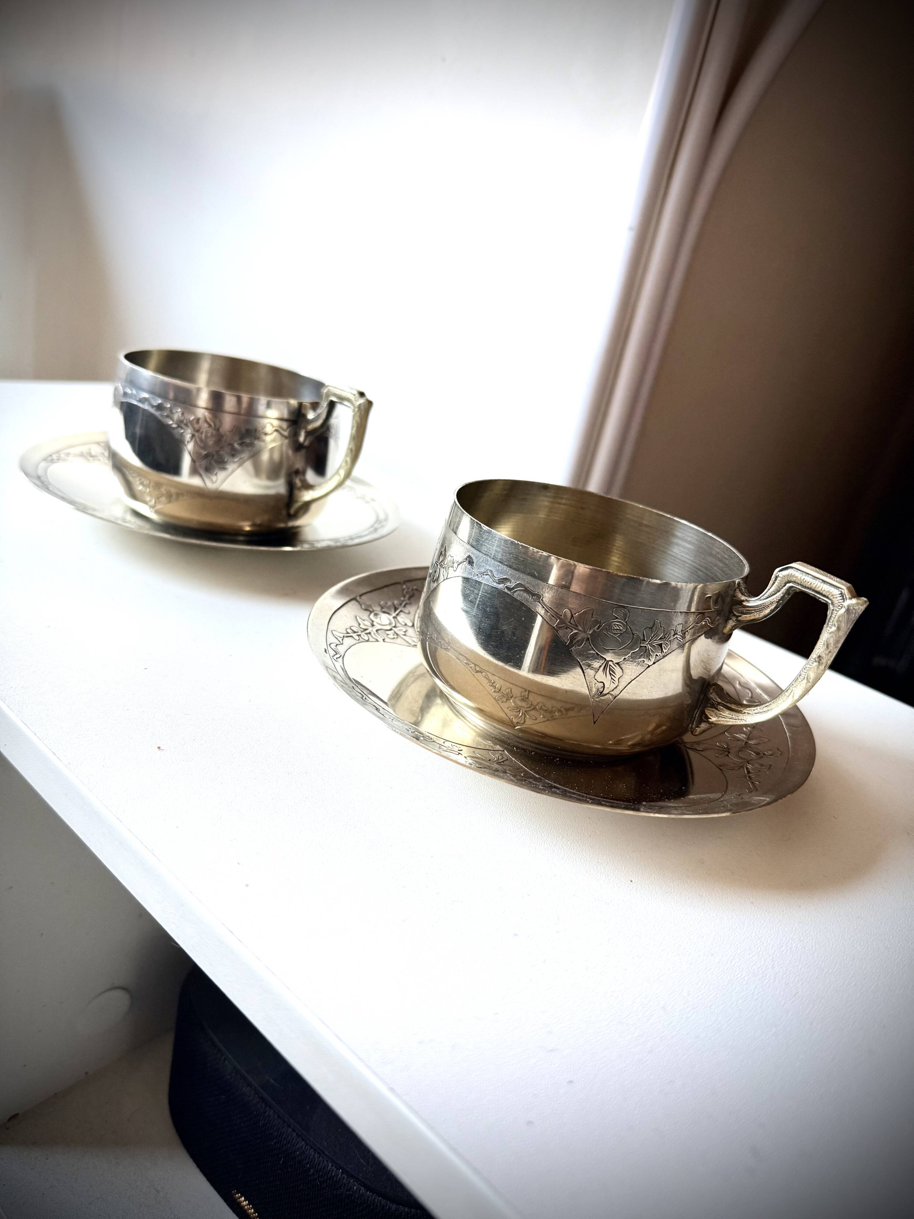 Set of 2 cups with silver-plated saucers, 19th century.