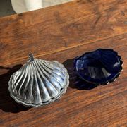 Vintage silver-plated shell butter dish with blue bowl.