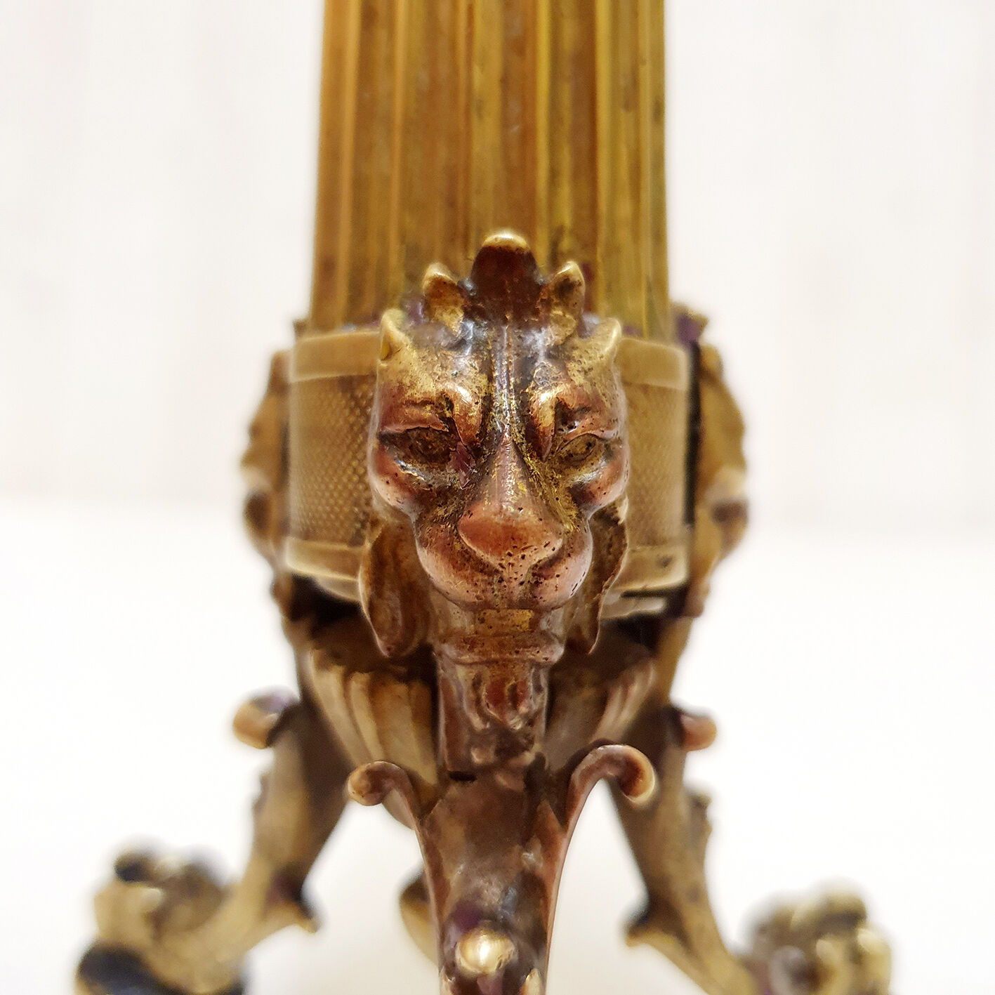 Golden candle holder with lion's head and legs