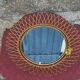 Vintage 1950s sun mirror in gold metal.