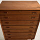 Restored teak chest of drawers with seven drawers.