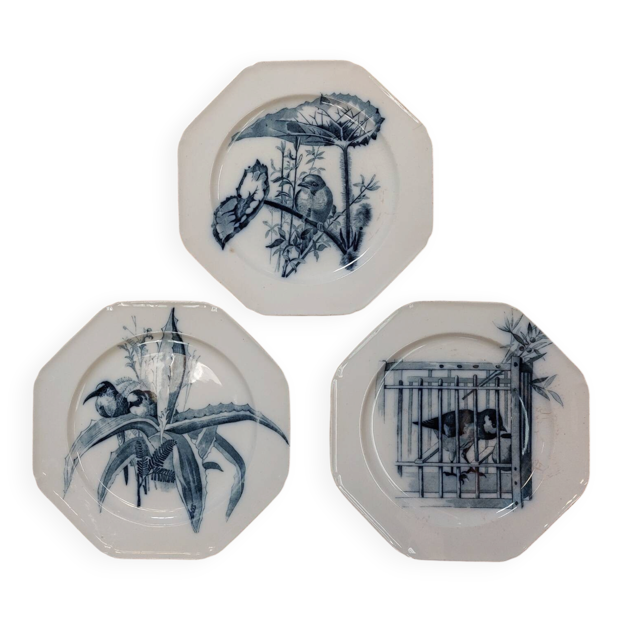 Set of three ironstone plates decorated with birds.
