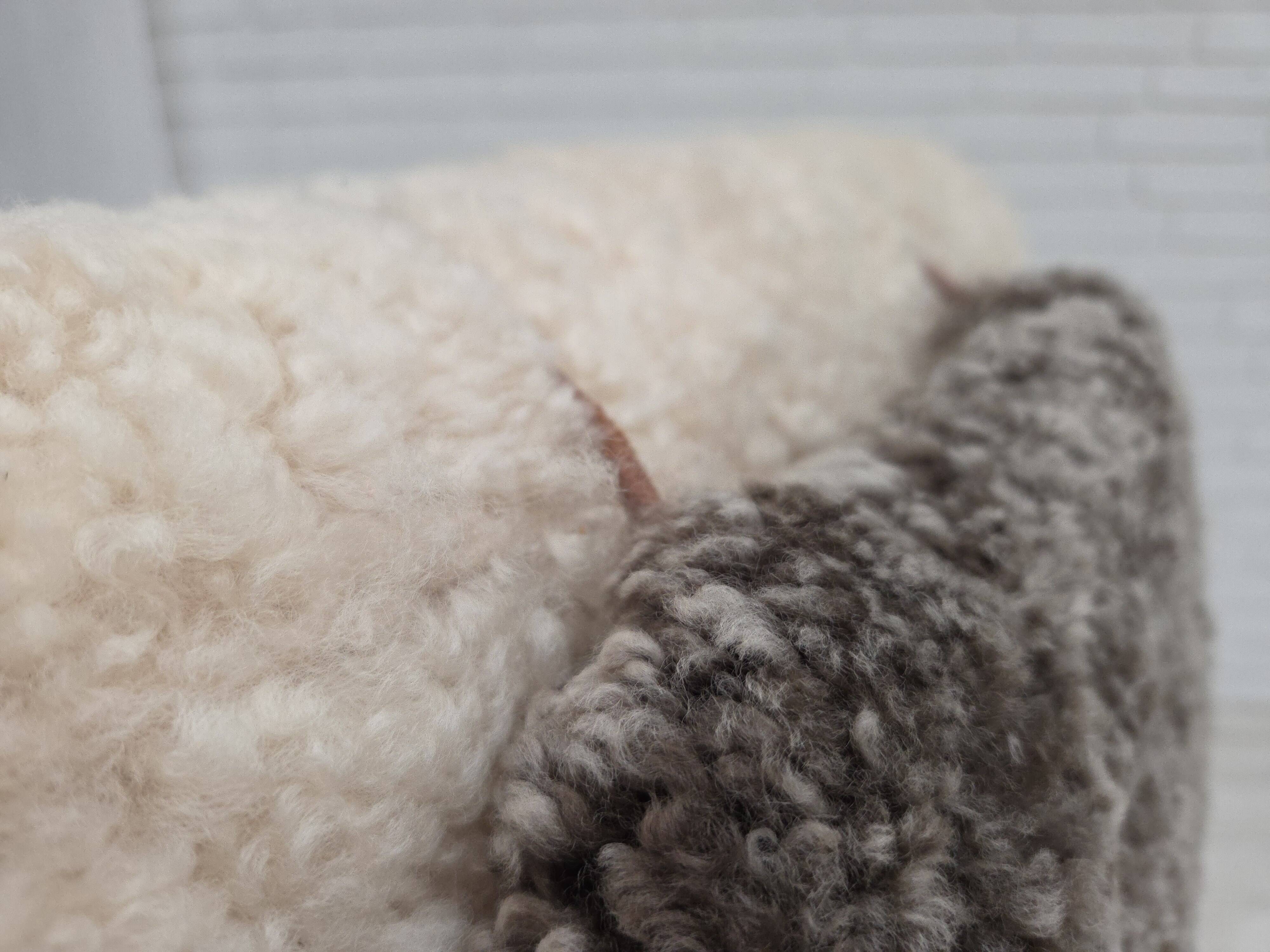 1970s, Danish rocking chair, reupholstered in quality genuine sheepskin.