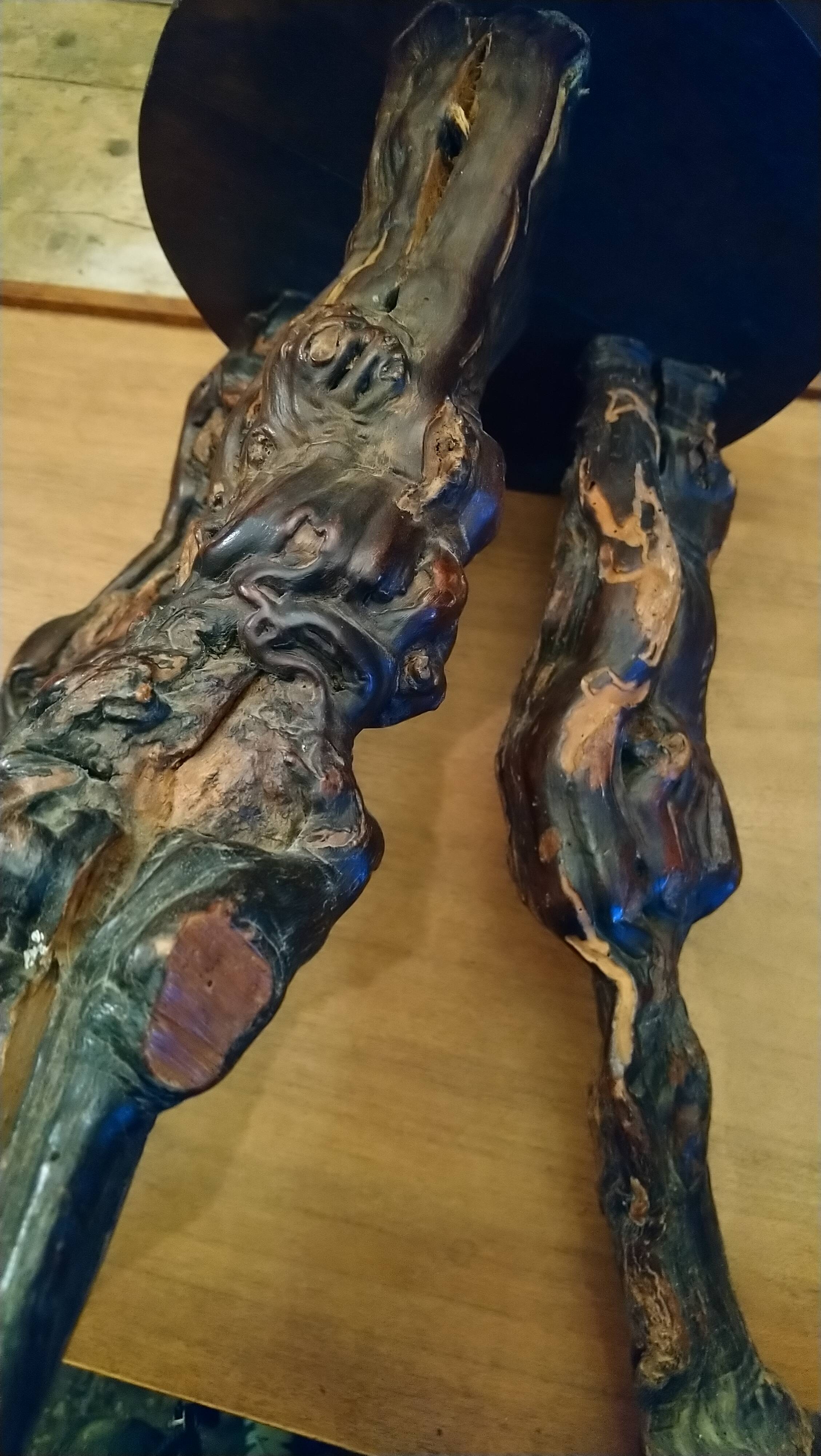 Brutalist tripod stool made from vine stumps.