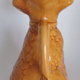 Ancient ceramic pitcher in the shape of a poodle.