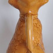 Ancient ceramic pitcher in the shape of a poodle.