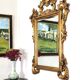 Large Italian mirror in carved wood, traditional gilding, 1980s.