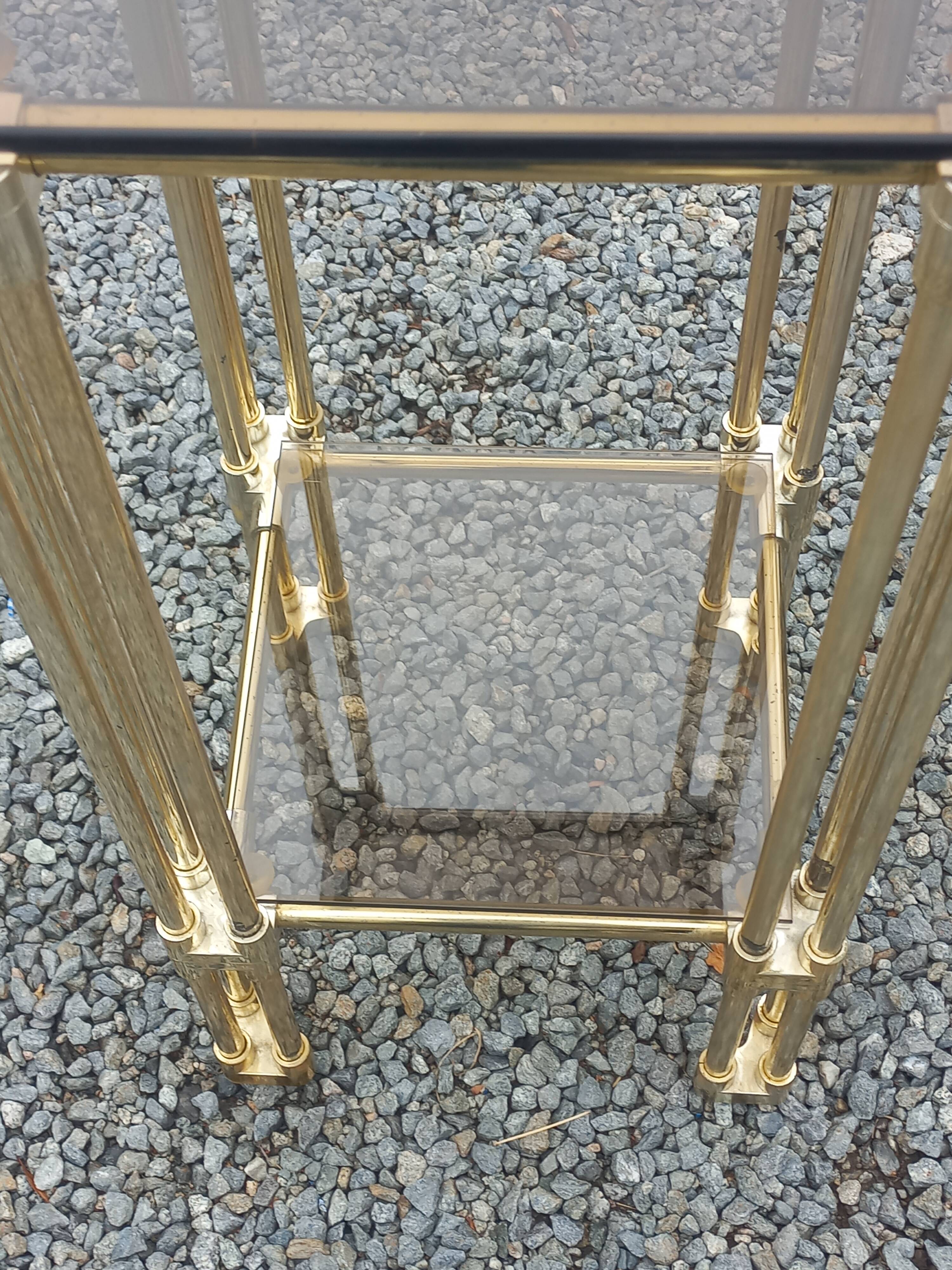 Pair of Hollywood Regency side tables in gold metal and smoked glass.