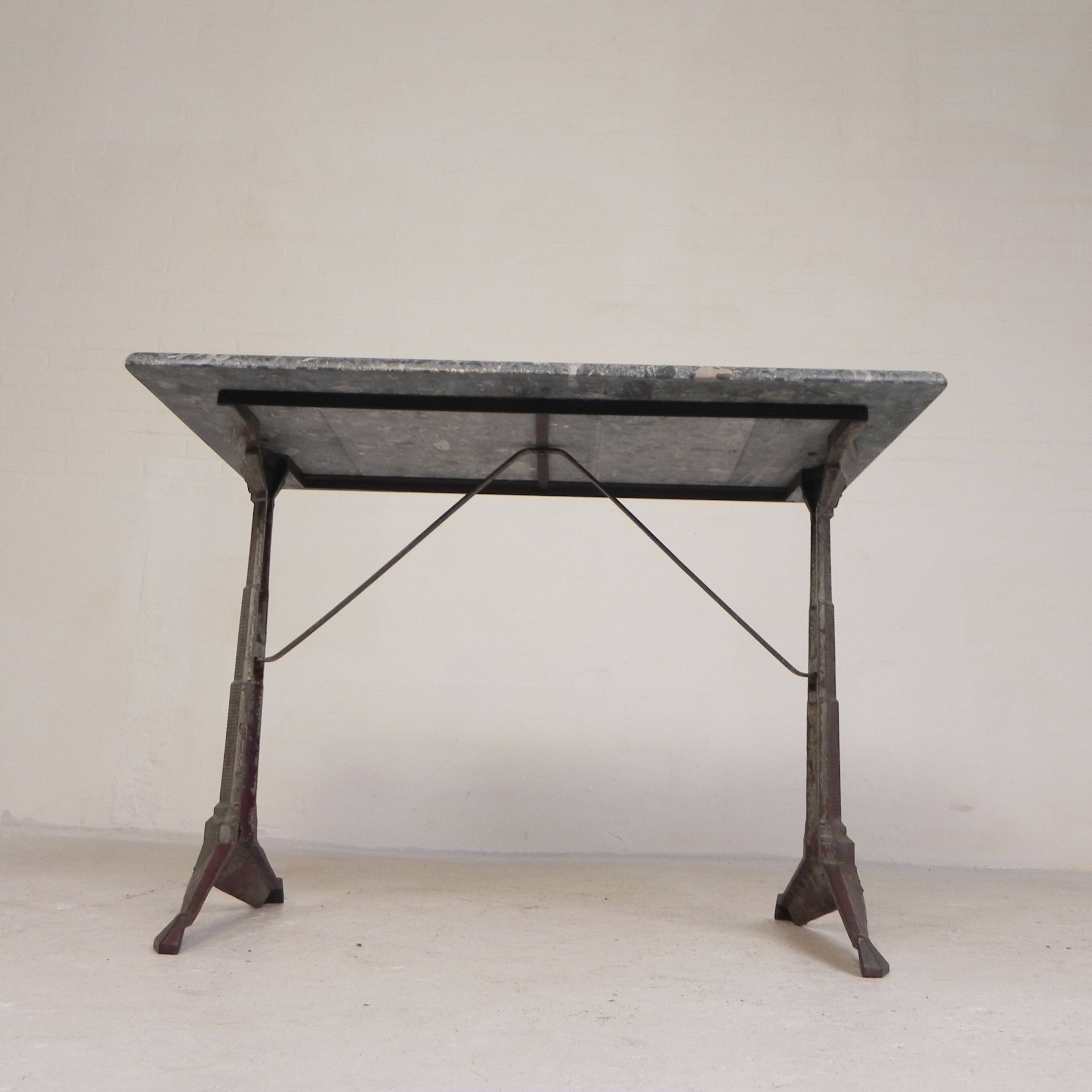 Bistro table with a marble top on a cast iron frame, 1930s.