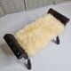 Carved wooden stool covered with Celtic-style sheepskin