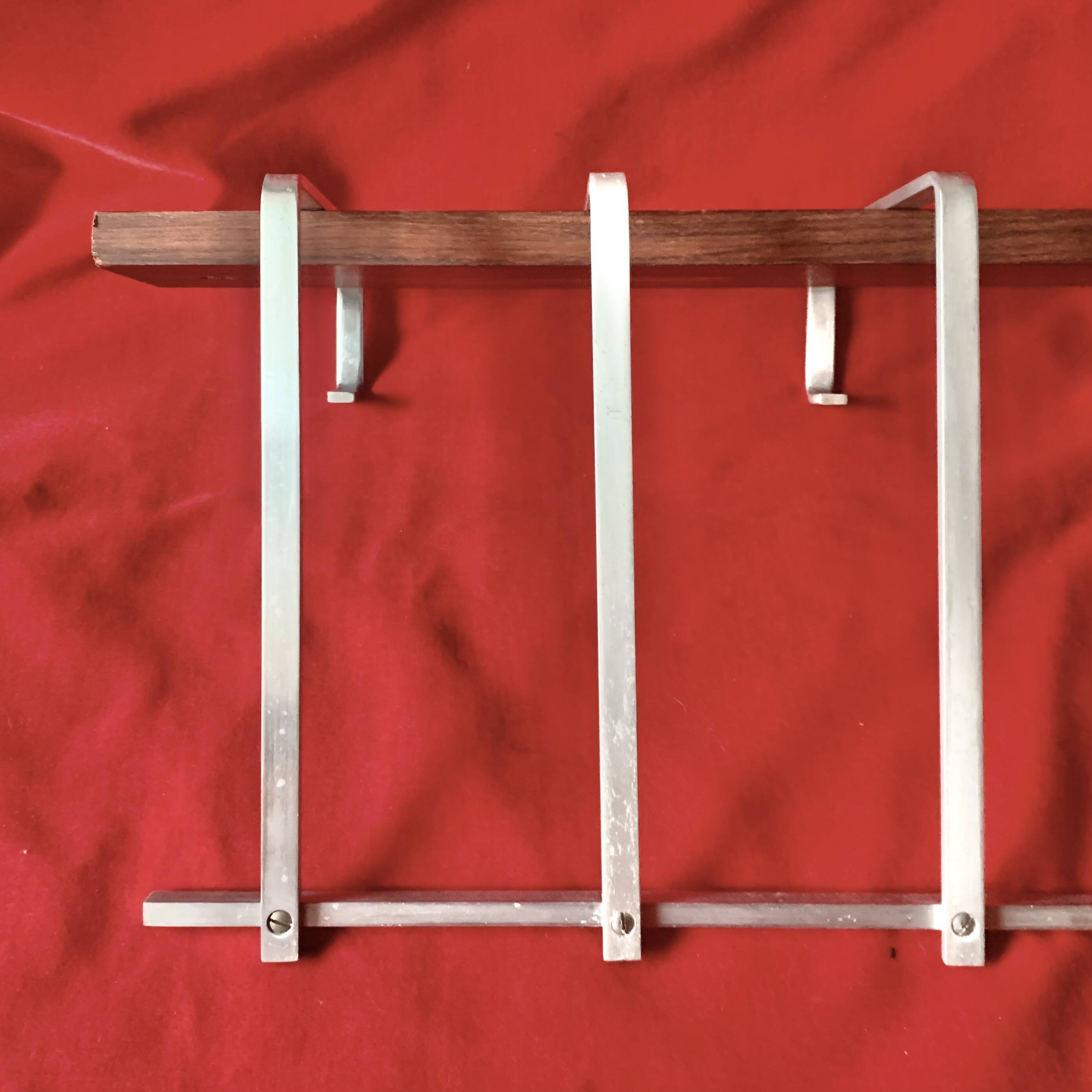 Vintage wall-mounted coat rack made of plywood and aluminum with hat rack