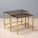 Nested tables in brass and smoked glass.