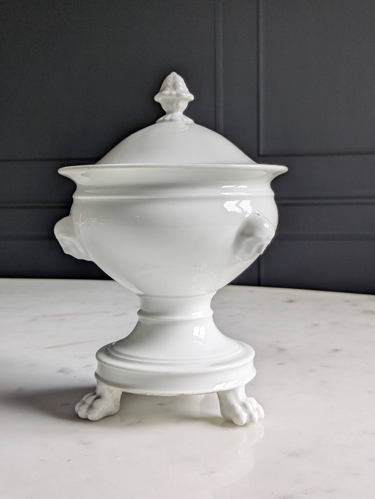 White porcelain confiturier with lion paws and masks. 19th century.