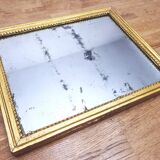 Old mercury mirror in carved wood, gilded with leaf.