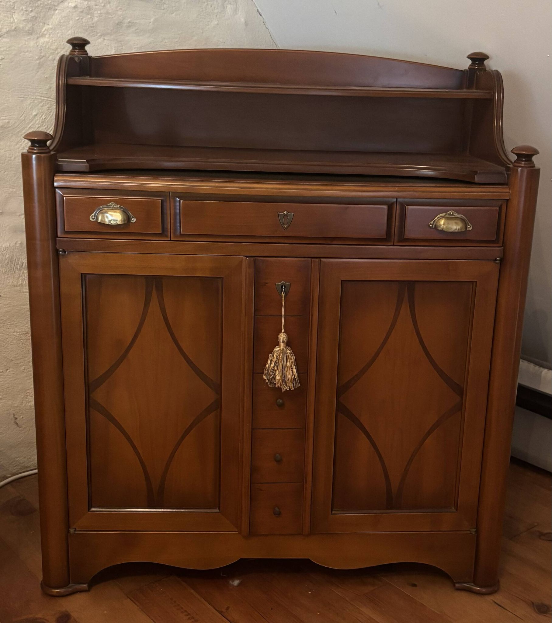 Vintage drop-leaf secretary with a green leather top and inlays.
