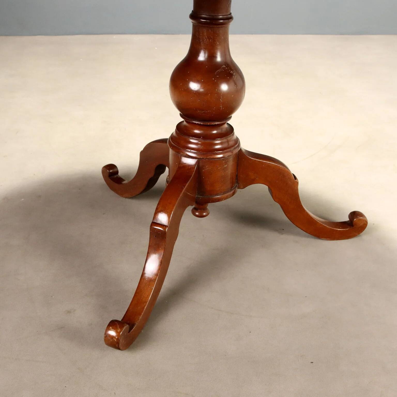 Antique round walnut table with a baluster central leg, Italy, 19th century.