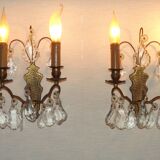 Pair of French antique brass double wall lights with assorted crystals.
