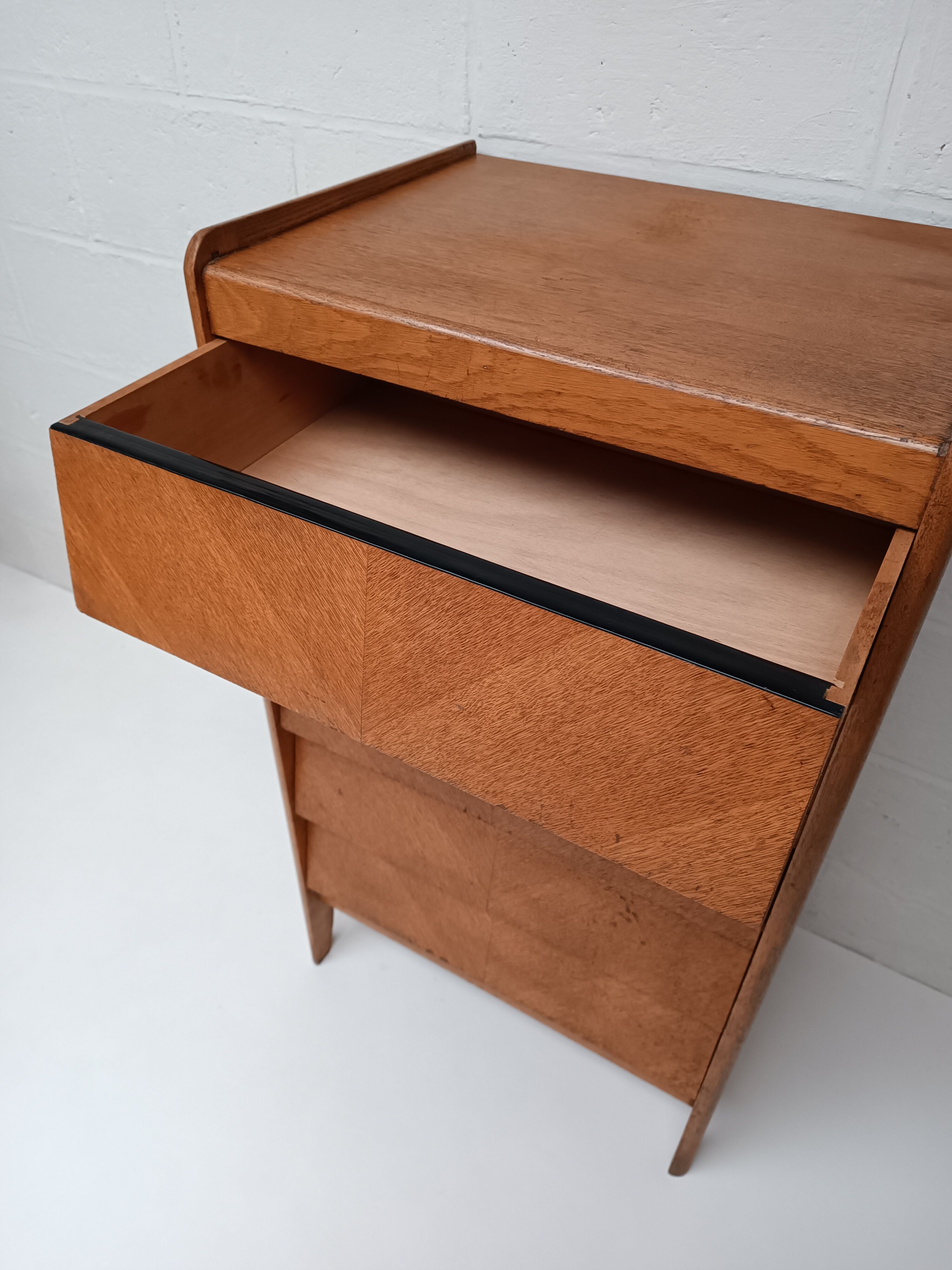 High wooden chest of drawers in the 50s