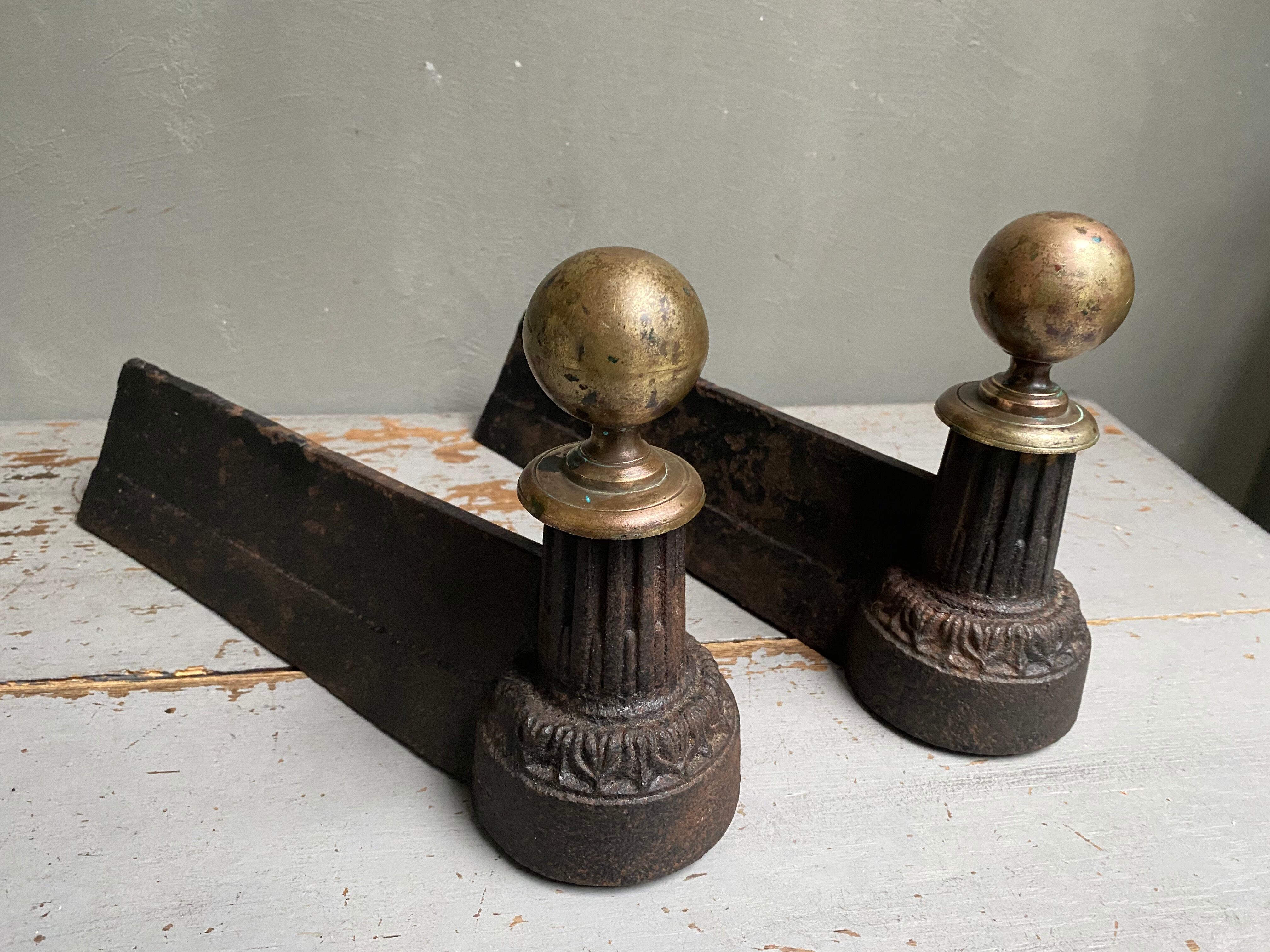 Pair of brass and cast iron ball pegs
