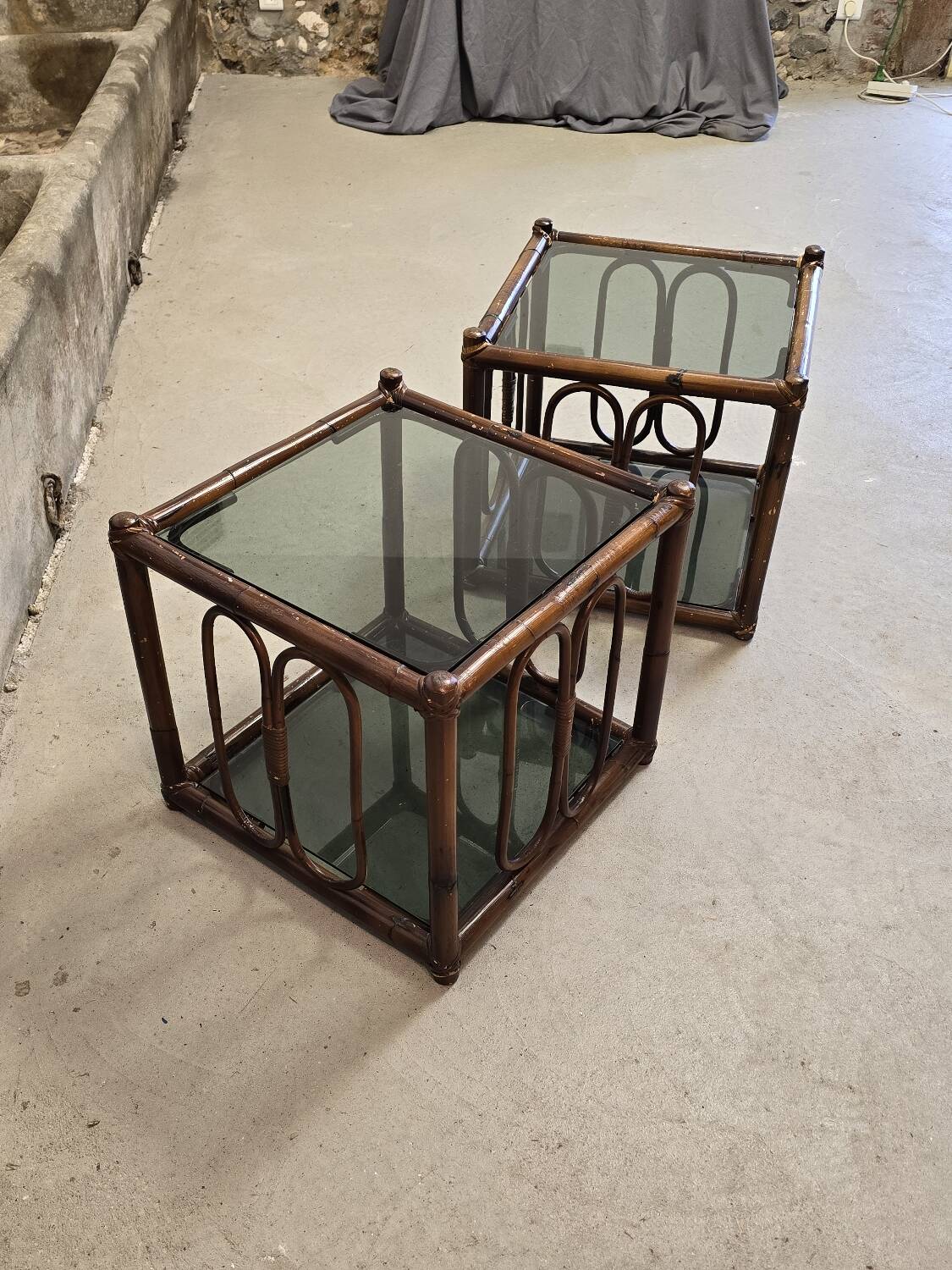 Two rattan and smoked glass tables, 1970