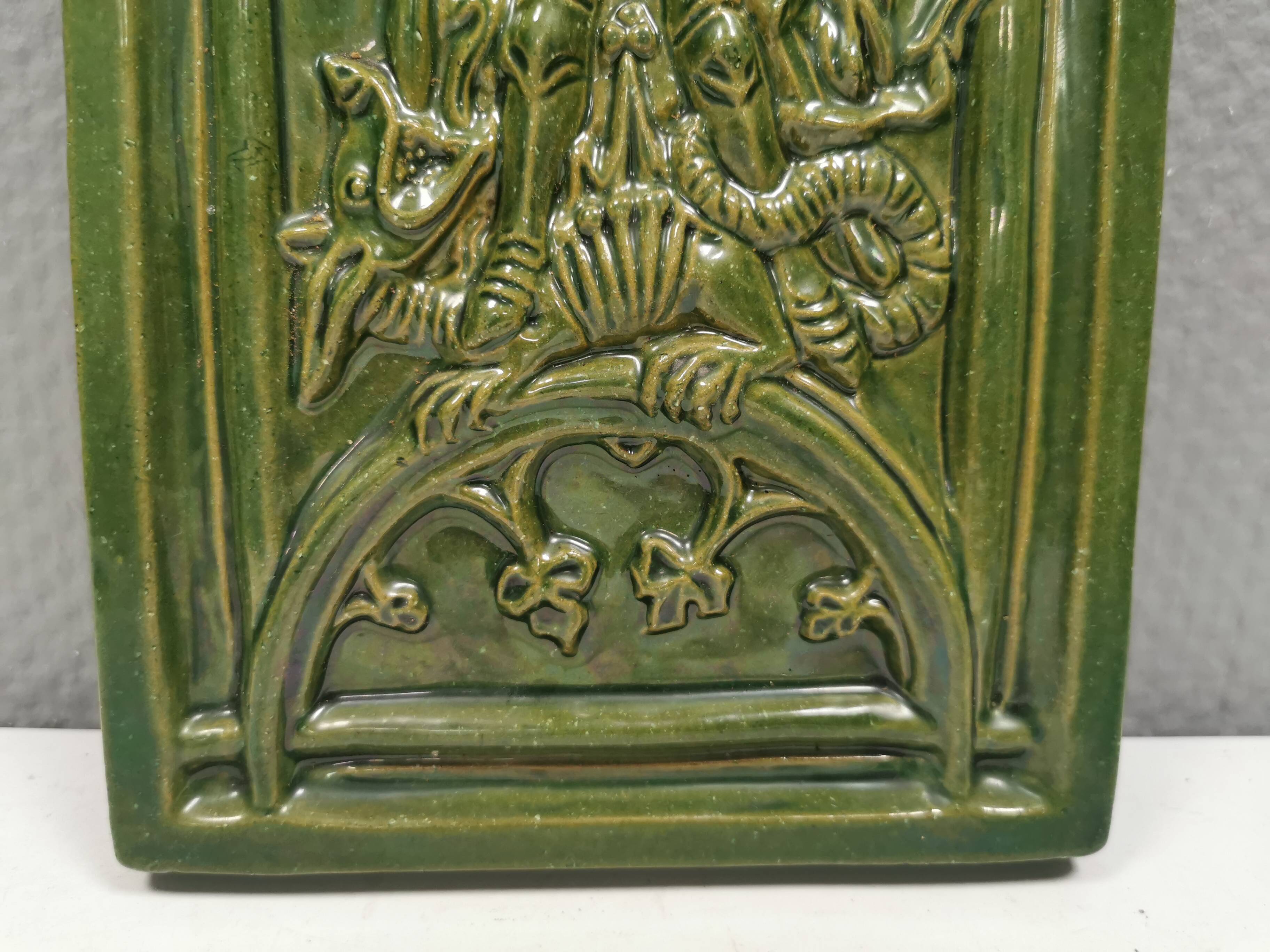 Antique tile in green faience, motif of Saint George and the dragon