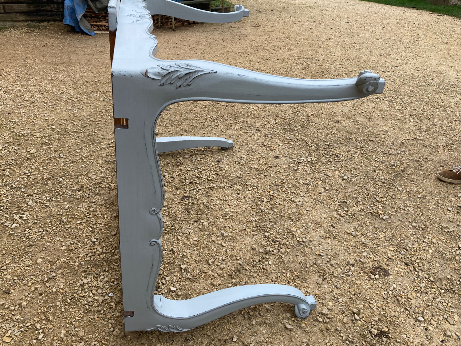 Louis XV style walnut table with a natural wood top.