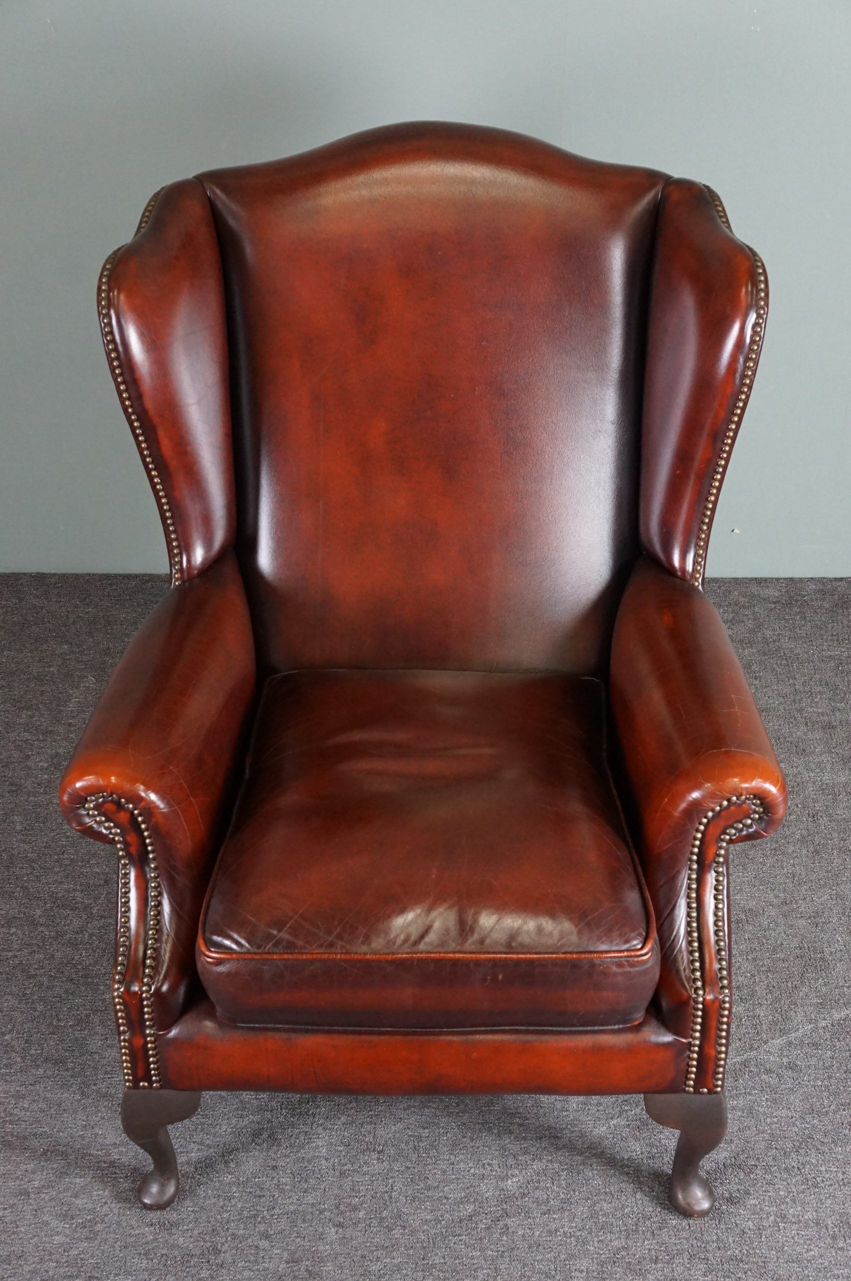 Leather armchair with decorative nails