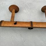Old rustic wooden coat rack turned in imitation of bamboo