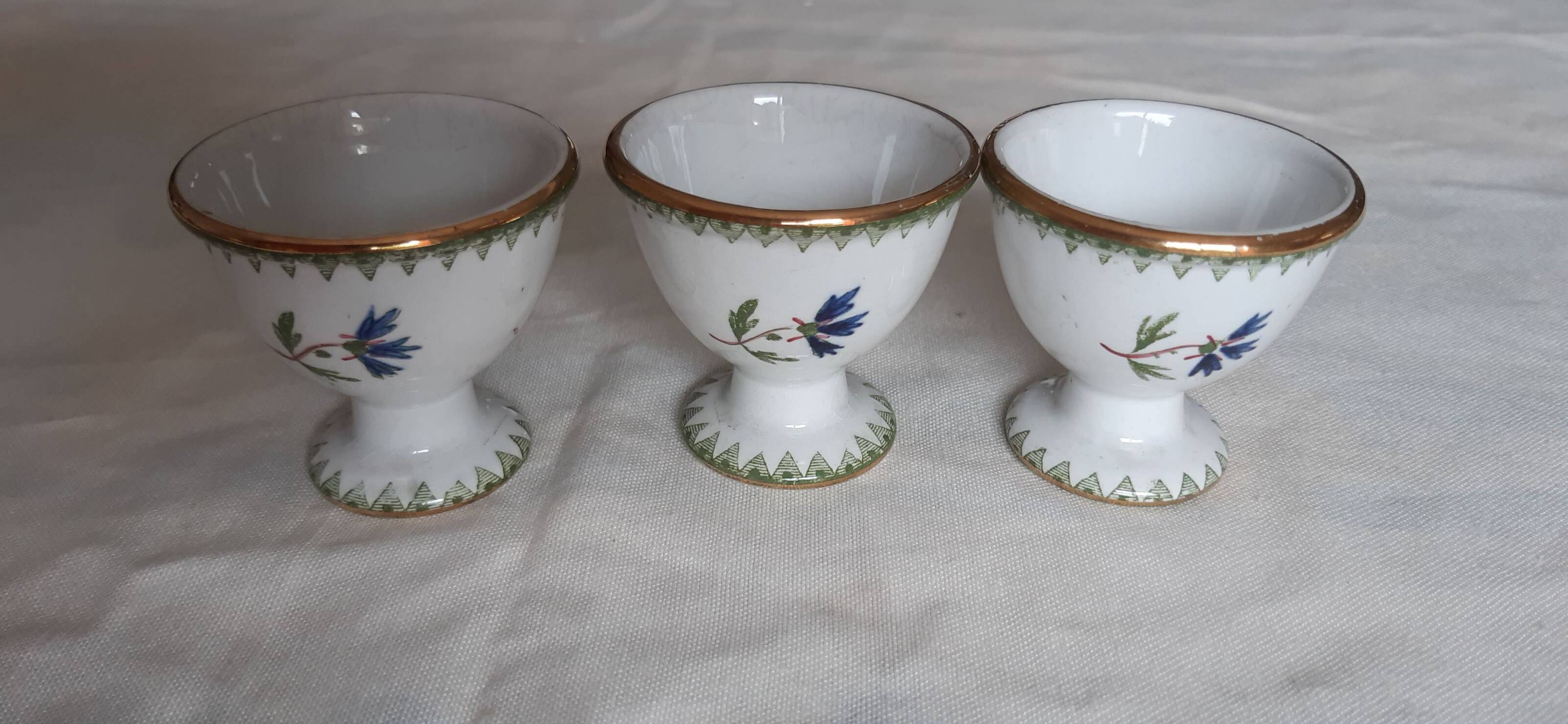 Set of three egg cups, barbel pattern decorations