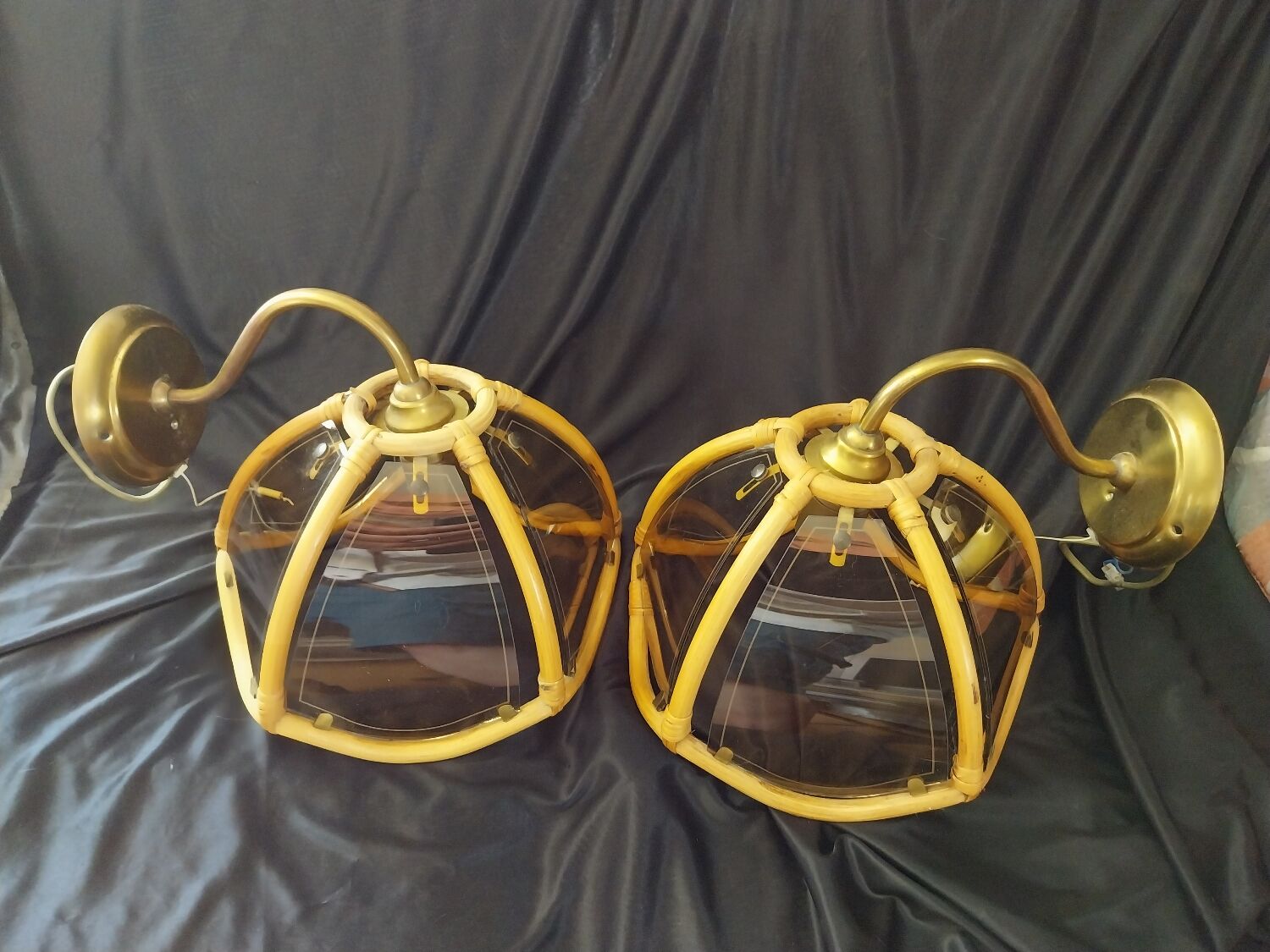 Wall sconces in rattan and smoked glass