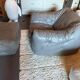 Sloop armchair and pouf from Ligne Roset in grey leather.