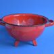 Vintage red enameled sheet metal colander