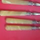 12 Cake forks. Around 1930. Golden metal and yellow Bakelite handle.
