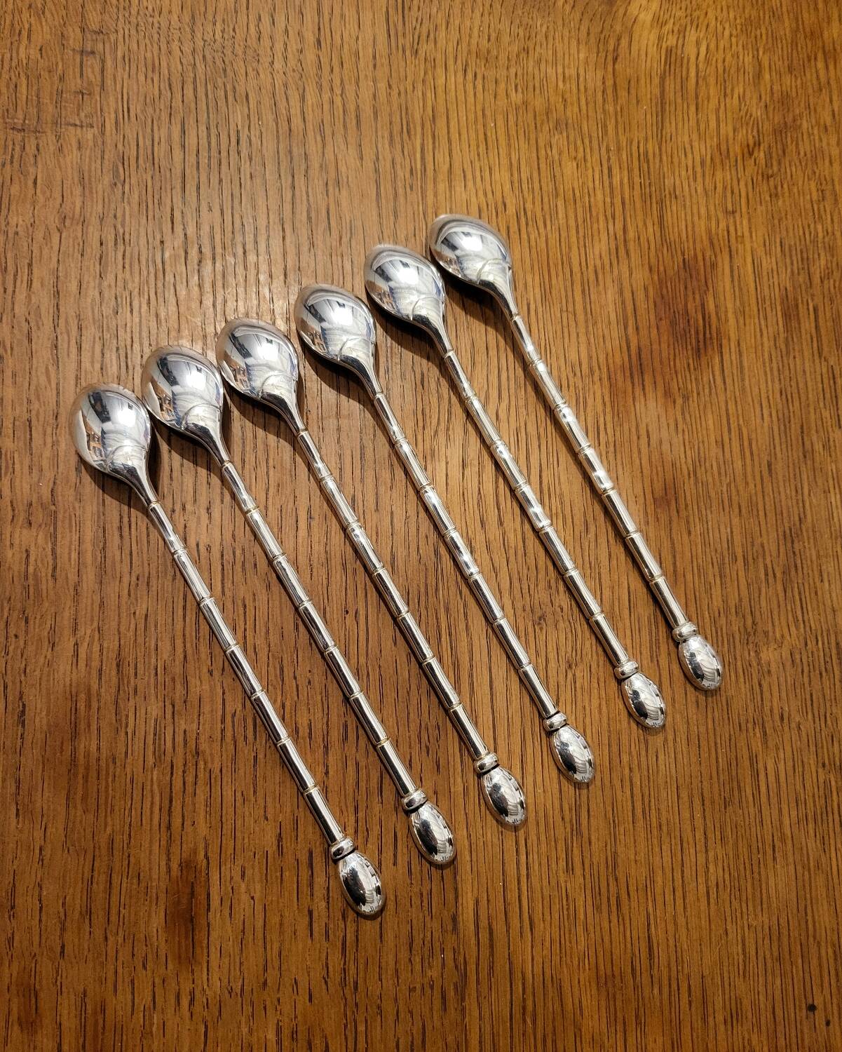 6 long silver-plated metal spoons