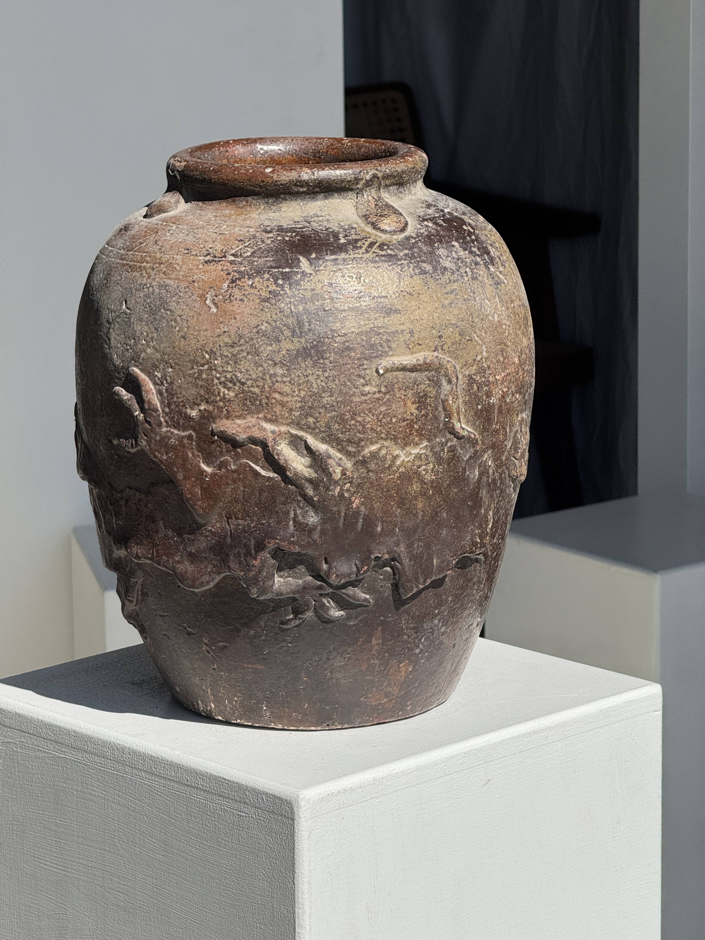 Large traditional Indonesian clay pot featuring a dragon.