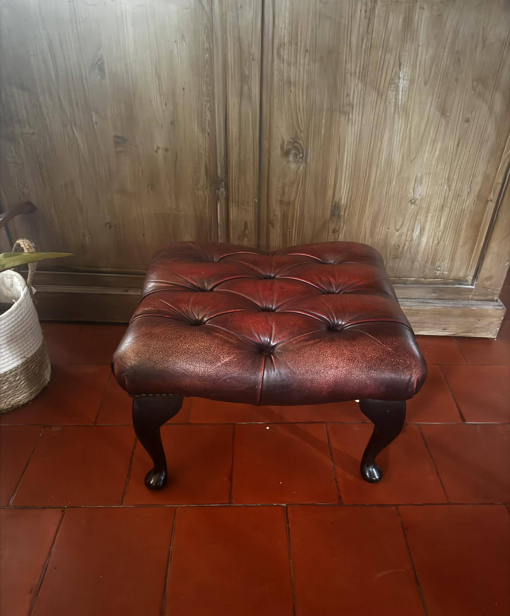 Red leather footrest in Chesterfield style, vintage 1970s.