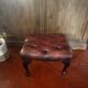 Red leather footrest in Chesterfield style, vintage 1970s.