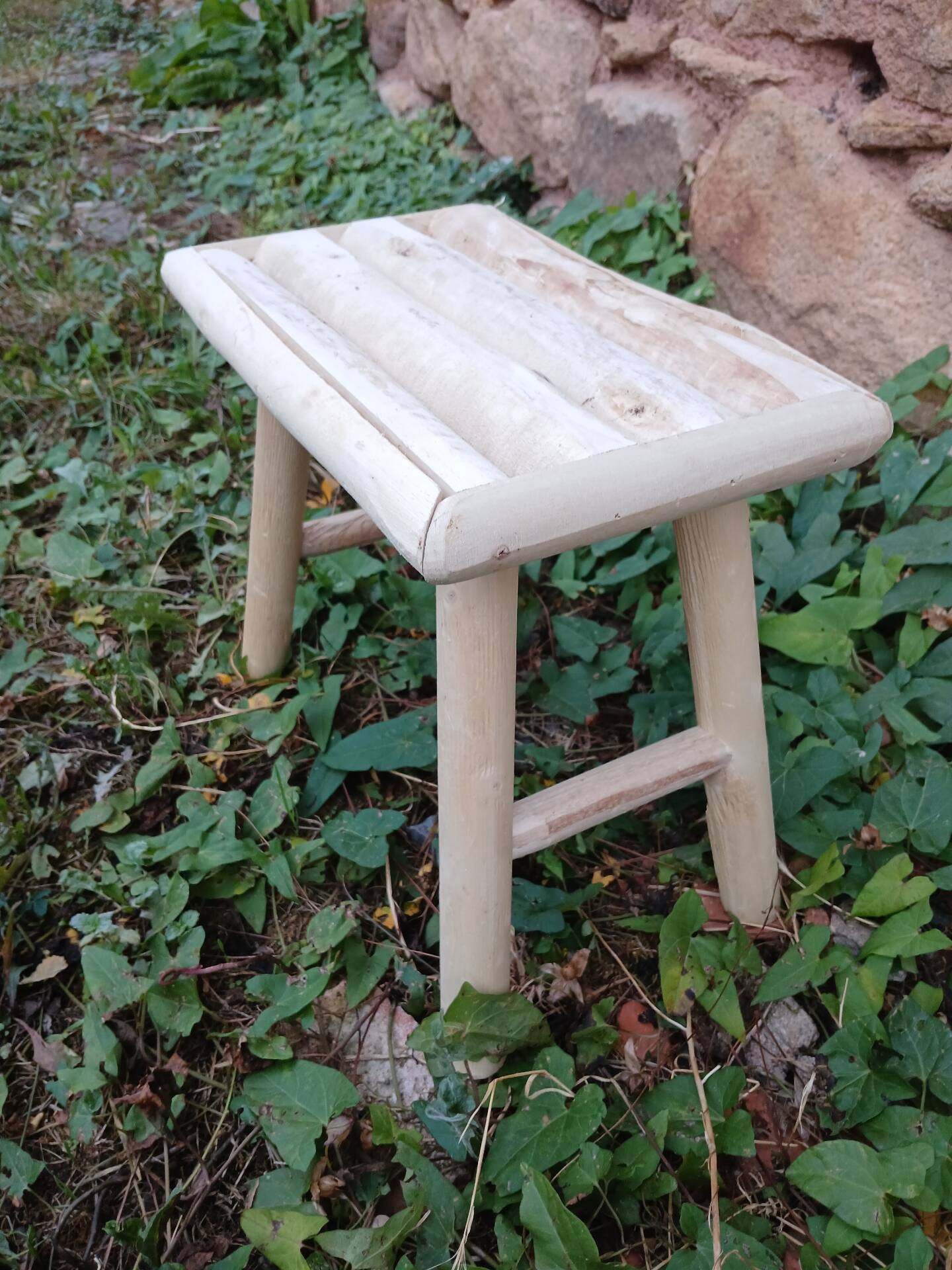 Small stool in raw wood
